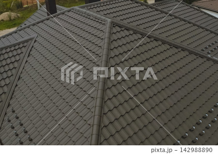 Corrugated metal roof and metal roofing. Modern roof made of metal. Corrugated metal roof and metal roofing. Modern roof made of metal. 142988890