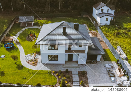 House with a gray metal roof. Corrugated metal roof and metal roofing. Modern roof made of metal. House with a gray metal roof. Corrugated metal roof and metal roofing. Modern roof made of metal. 142988905