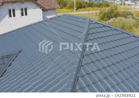 Corrugated metal roof and metal roofing. Modern roof made of met 142988922