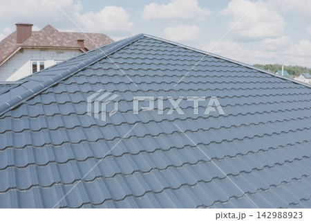 Corrugated metal roof and metal roofing. Modern roof made of met Corrugated metal roof and metal roofing. Modern roof made of met 142988923