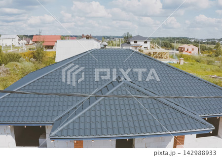 Corrugated metal roof and metal roofing. Modern roof made of met 142988933