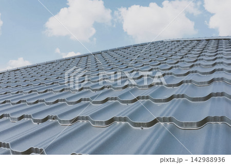 Corrugated metal roof and metal roofing. Modern roof made of met Corrugated metal roof and metal roofing. Modern roof made of met 142988936