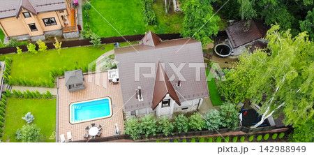 new house, the roof of which is made of metal. Cottage in the countryside. new house, the roof of which is made of metal. Cottage in the countryside. 142988949