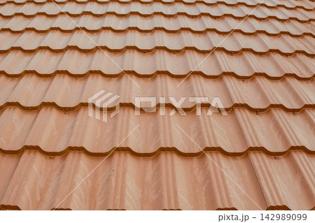 Corrugated metal roof and metal roofing. Modern roof made of metal. Corrugated metal roof and metal roofing. Modern roof made of metal. 142989099