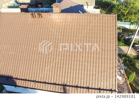 Corrugated metal roof and metal roofing. Modern roof made of metal. 142989181