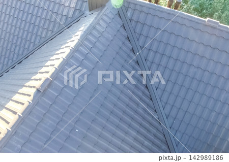 Corrugated metal roof and metal roofing. Modern roof made of metal. Corrugated metal roof and metal roofing. Modern roof made of metal. 142989186