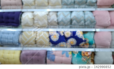 Blurred Shelves of Colorful Cushions and Pillows in Home Store Blurred Shelves of Colorful Cushions and Pillows in Home Store 142990852