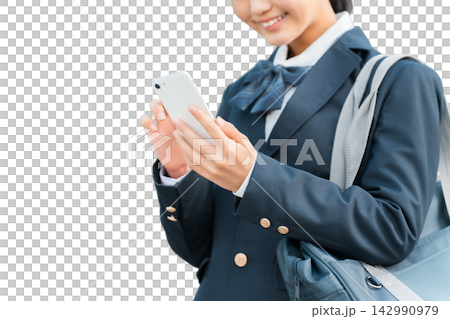 Junior high and high school girls in school uniforms looking at their smartphones. Junior high and high school girls in school uniforms looking at their smartphones. 142990979