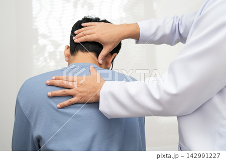 Physical therapy, Asian therapist doctor treat perform pain young man in hospital. Physical therapy, Asian therapist doctor treat perform pain young man in hospital. 142991227