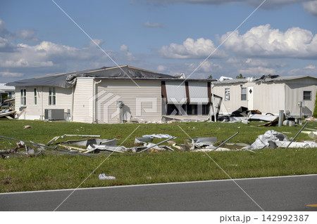Severely damaged houses after hurricane in Florida mobile home residential area. Consequences of natural disaster 142992387