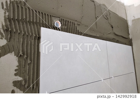 Wall ceramic tiles installation on mortar glue. Wall ceramic tiles installation on mortar glue. 142992918