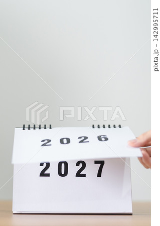 2026 to 2027 New Year Concept. Hand Turning Calendar Page Representing New Beginning, Year Transition, Future Planning, Change, Growth, Goal Setting and Fresh Start 2026 to 2027 New Year Concept. Hand Turning Calendar Page Representing New Beginning, Year Transition, Future Planning, Change, Growth, Goal Setting and Fresh Start 142995711