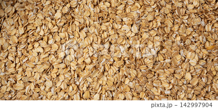 Oat flakes textured pattern, rolled oatmeal macro background Oat flakes textured pattern, rolled oatmeal macro background 142997904