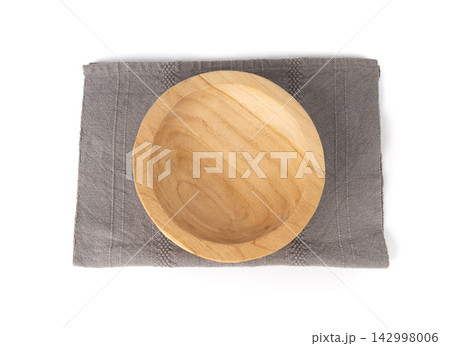 Empty wood bowl isolated, light plate on grey tablecloth, rustic dish mockup on cloth napkin 142998006