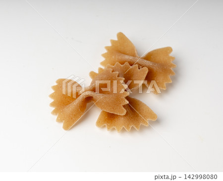 Raw Brown Farfalle Pasta Isolated Raw Brown Farfalle Pasta Isolated 142998080