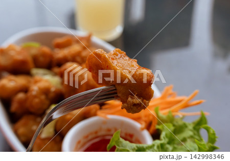 Crispy chicken popcorn with tomato sauce closeup Crispy chicken popcorn with tomato sauce closeup 142998346