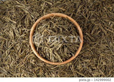 Green tea leaves macro textured background 142999002