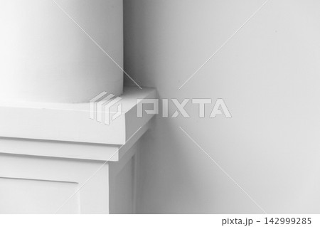 Minimal column base and decorative molding are in front of white wall Minimal column base and decorative molding are in front of white wall 142999285