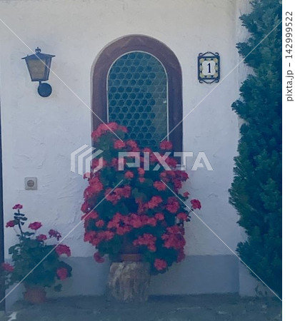 Traditional window with metal grid and blooming flowers in Mittenwald, Bavaria, Germany Traditional window with metal grid and blooming flowers in Mittenwald, Bavaria, Germany 142999522