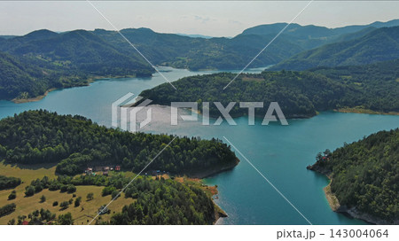 Zaovinsko Lake surrounded by forested hills and mountain in Serbia 143004064