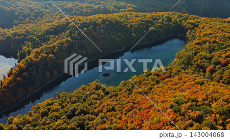 Biogradsko lake surrounded by mountains covered with bright autumn trees Biogradsko lake surrounded by mountains covered with bright autumn trees 143004068