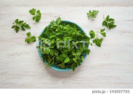 Fresh organic flat-leaf parsley as nutrient-rich superfood for vegan diet Fresh organic flat-leaf parsley as nutrient-rich superfood for vegan diet 143007793