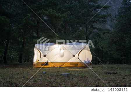 A Cozy Camping Tent Illuminated in the Beautiful Forest at Dusk During Evening Time 143008153