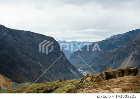Majestic Mountain Valley Landscape Displayed Beautifully Under an Overcast Sky Above Majestic Mountain Valley Landscape Displayed Beautifully Under an Overcast Sky Above 143008225