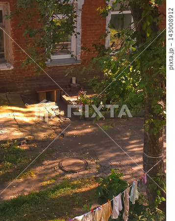 Courtyard with laundry line and red brick house windows Courtyard with laundry line and red brick house windows 143008912
