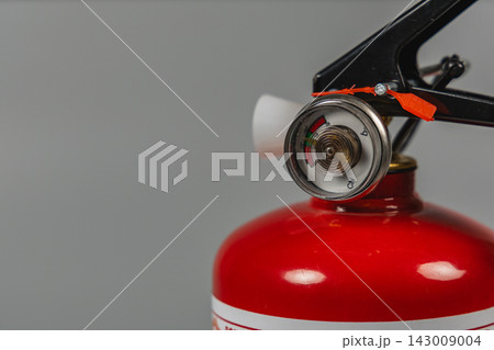 Fire extinguisher with pressure gauge and handle in focus Fire extinguisher with pressure gauge and handle in focus 143009004
