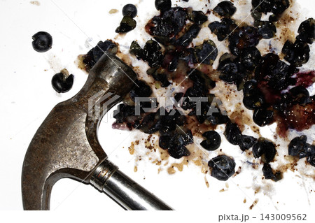 Squashed and crushed blueberries fruit berries splattered with a hammer on a white background with juice Squashed and crushed blueberries fruit berries splattered with a hammer on a white background with juice 143009562