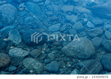 Clear Water Over River Rocks and Pebbles 143009978