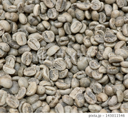 Close-up texture of raw green unroasted coffee beans Close-up texture of raw green unroasted coffee beans 143011546