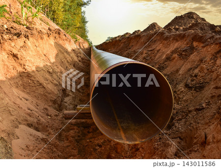Pipeline Construction. Natural Gas Pipeline trench in ground on sunset.  LNG, LPG. Oil and Gas  143011586