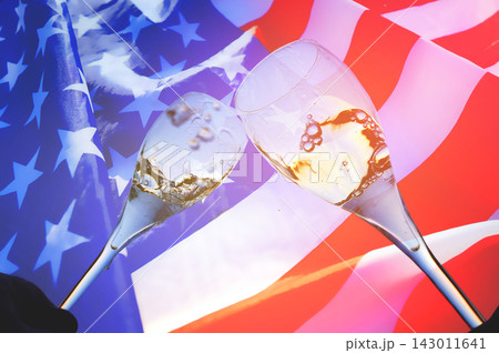 Glasses of sparkling wine on United States flag background. Celebration of US Independence Day Glasses of sparkling wine on United States flag background. Celebration of US Independence Day 143011641