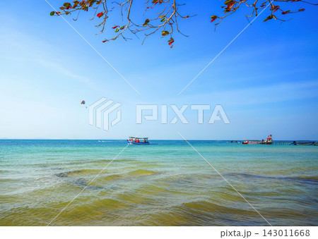 Fast motorboat carries tourists across ocean. Boat moves sea on sunny day at coastline in tropical Fast motorboat carries tourists across ocean. Boat moves sea on sunny day at coastline in tropical 143011668