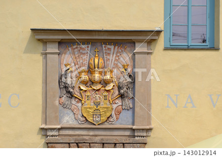 Decorative prague historic building facade with gilded coat of arms relief for travel background and architectural detail poster Decorative prague historic building facade with gilded coat of arms relief for travel background and architectural detail poster 143012914
