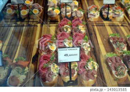 Closeup chlebicek open faced sandwiches in prague deli display with cured meat and egg garnish for menu background and food banner design 143013585