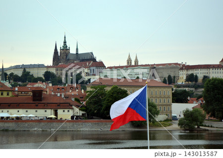 Czech republic flag flying over the vltava river with prague castle skyline for travel background and landmark banner 143013587