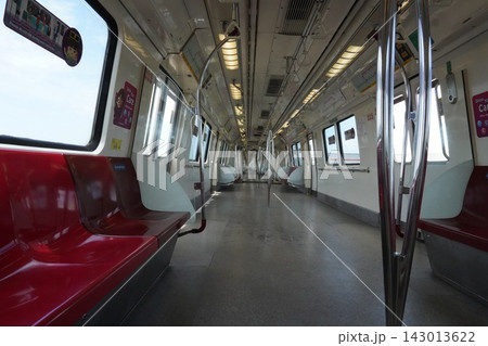 Empty subway train car interior with red seats and bright windows Empty subway train car interior with red seats and bright windows 143013622