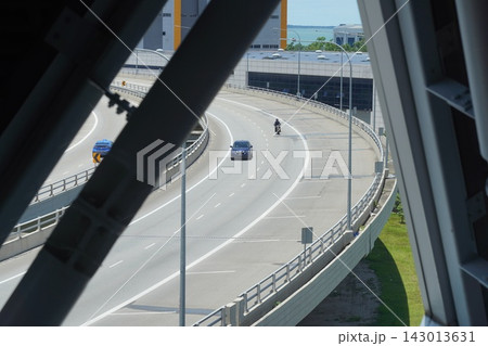 Busy elevated highway with cars and motorcycle under bright sun Busy elevated highway with cars and motorcycle under bright sun 143013631