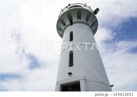 Tall White Lighthouse Structure Under Bright Sky Tall White Lighthouse Structure Under Bright Sky 143013651