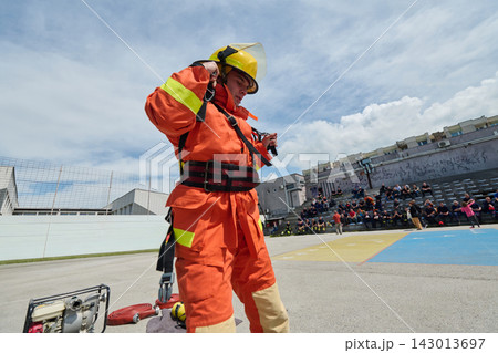 Firefighter Training Drill With Rescue Gear And Helmet During Outdoor Emergency Response Exercise 143013697