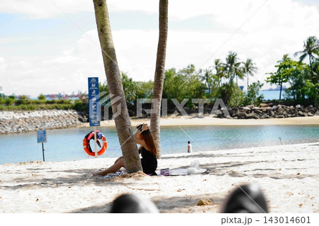 Woman relaxing on a beautiful tropical beach Woman relaxing on a beautiful tropical beach 143014601