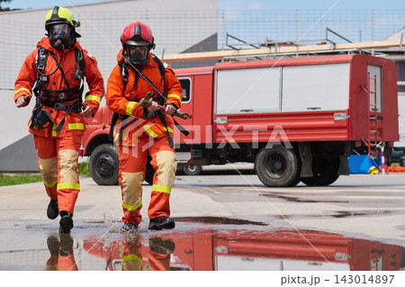 Firefighters In Protective Gear Running From Fire Truck During Emergency Response And Rescue Drill 143014897