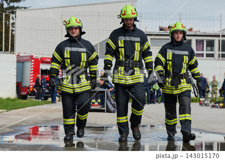 Three Firefighters Walking Together in Full Protective Gear During Emergency Response Training 143015170