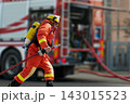 Firefighter in Full Gear Running With Hose Toward Fire Truck During Emergency Response Drill 143015523