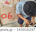 man changing wheel on a motorcycle 143016297