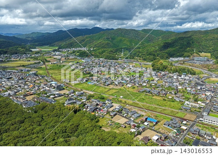 高知県黒潮町の住宅街と田畑・山並みを捉えた空撮写真 143016553