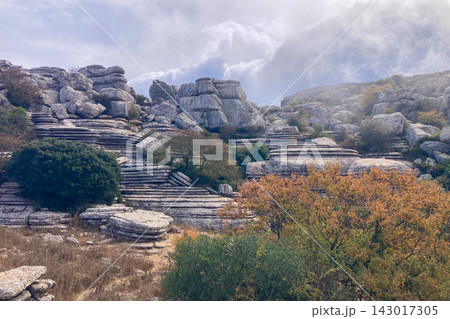 A mystical morning walk through the rocky landscapes of Torcal de Antequera in Andalusia, Spain, as soft mist drifts under the gentle rays of the sun. A mystical morning walk through the rocky landscapes of Torcal de Antequera in Andalusia, Spain, as soft mist drifts under the gentle rays of the sun. 143017305